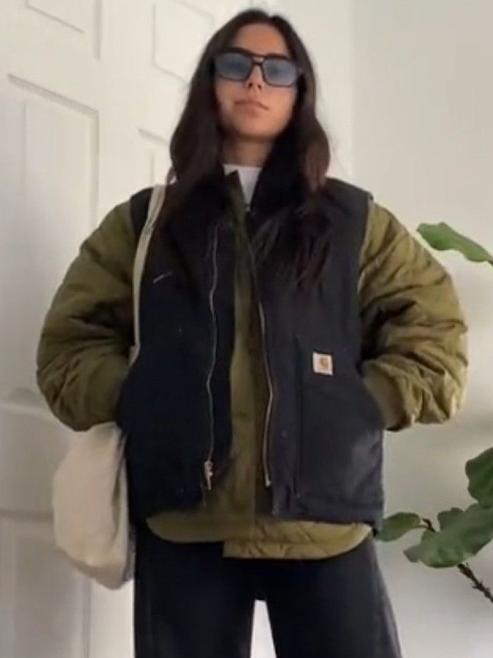 Carhartt Black Insulated Vest Over Olive Green Quilted Jacket